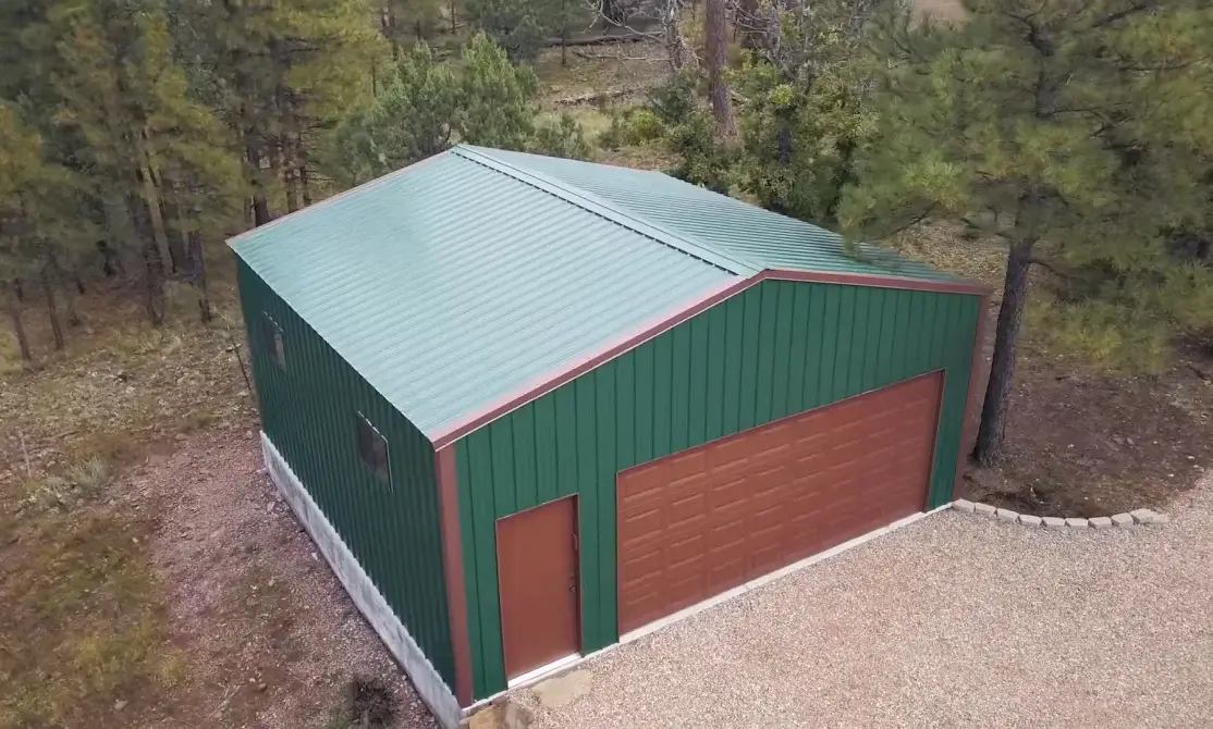 VersaTube customer testimonial video thumbnail showing Summit Garage with gable garage door and gable walk door with green sheet metal and brown doors and trim.